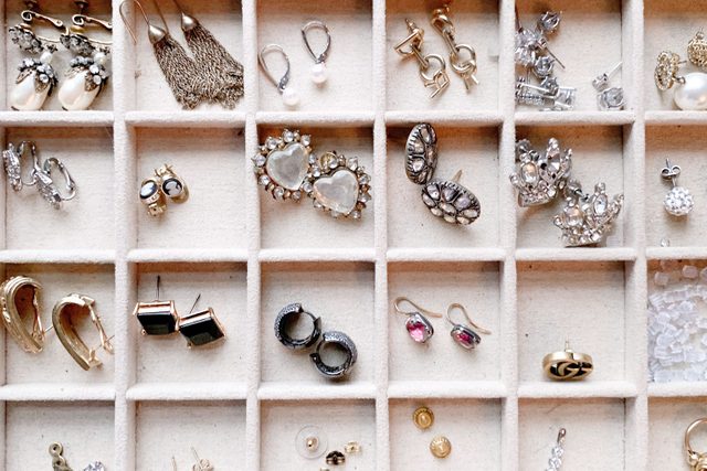 overhead view of jewelry and earrings organized into a section tray