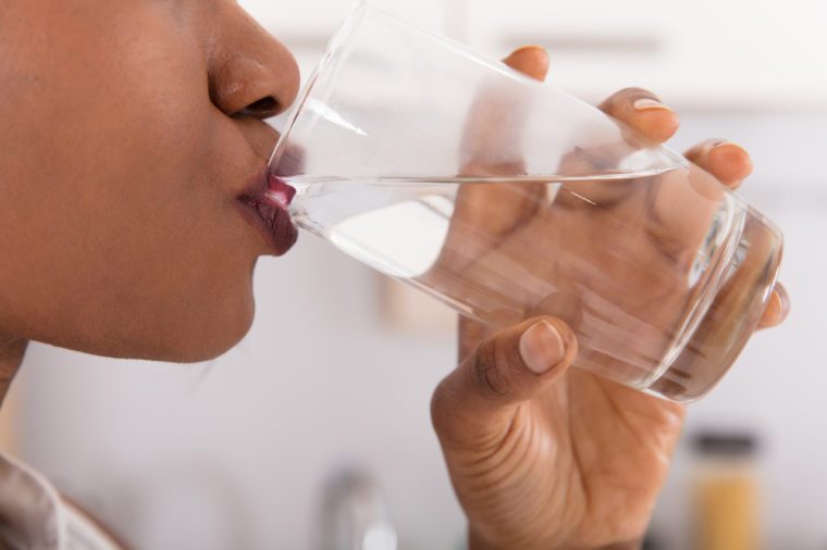 Close-up Of A Woman's Hand Drinking Glass Of Water