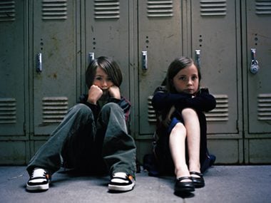 Kids sitting by the locker