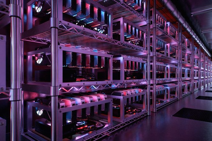Inside a data center for cryptocurrency mining with endless racks of CPU and motherboards. Processing the exchange of digital coins