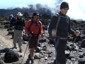 men climbing kilimanjaro