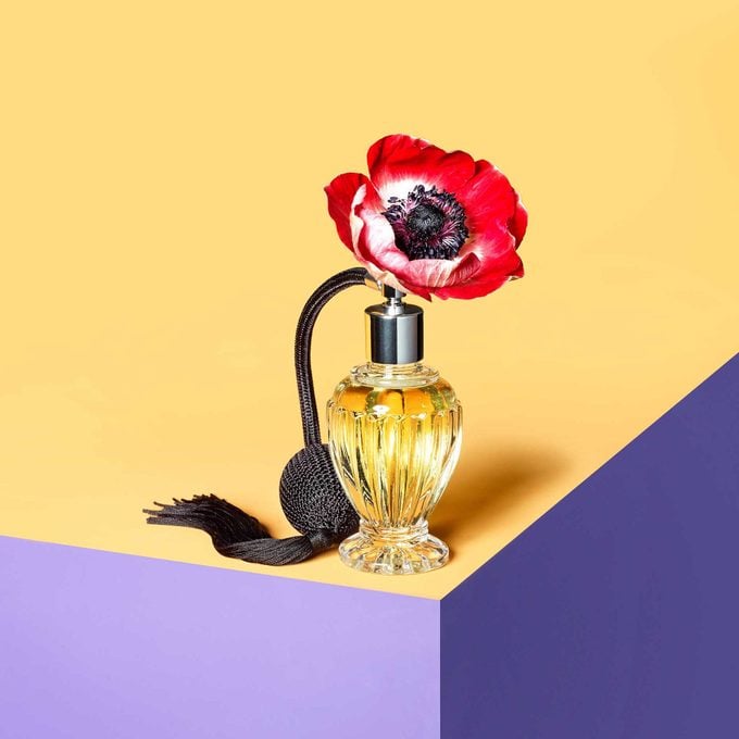 a flower in a perfume bottle