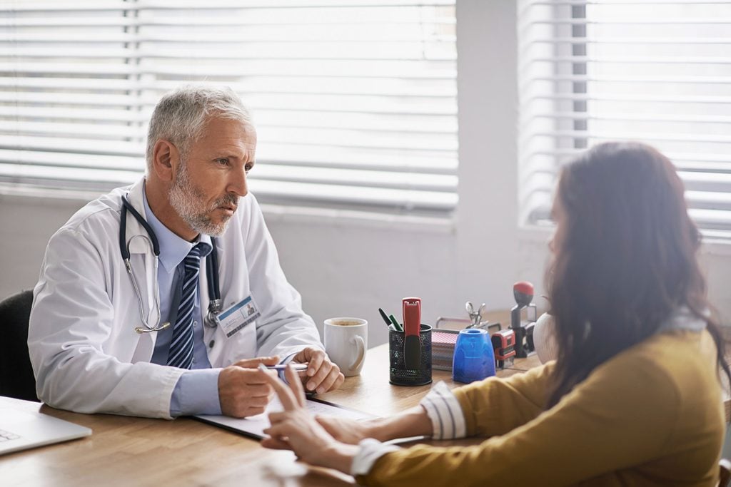 doctor discussing diagnosis with a woman patient