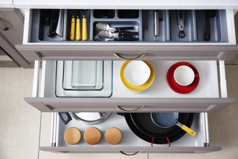 Set of clean kitchenware and utensils in drawersSet of clean kitchenware and utensils in drawers