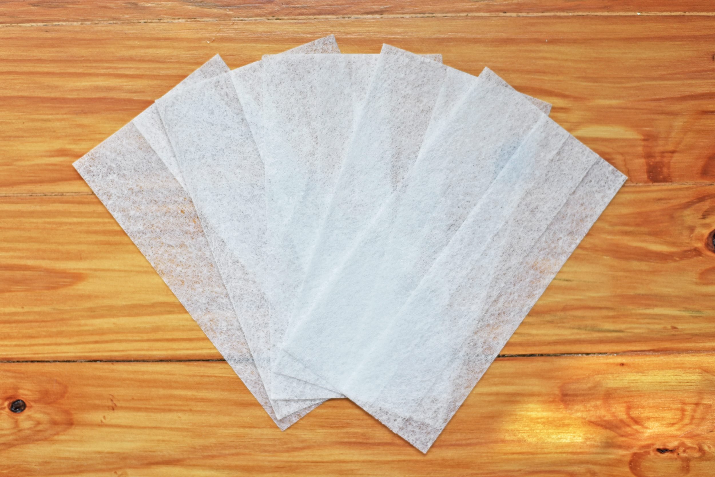 dryer sheets fanned out on a wood background