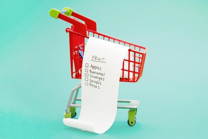 miniature shopping cart with grocery list