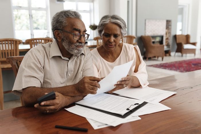 elderly couple reviewing documents