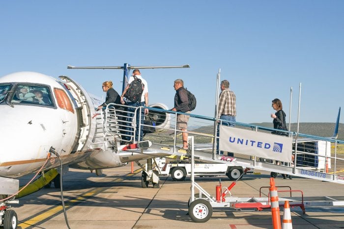 Passengers board a United Express passenger airplane at Santa Fe Municipal Airport in Santa Fe, New Mexico.