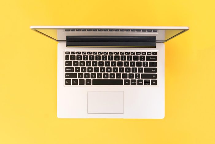 laptop on a yellow background, top view