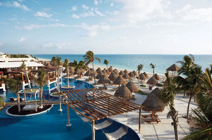 tropical pool side resort with palm trees at of Excellence Playa Mujeres