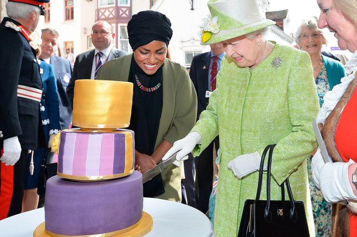 Queen Elizabeth II receives a birthday cake from Nadiya Hussain, winner of the Great British Bake Off, during her 90th Birthday Walkabout on April 21, 2016 in Windsor, England.