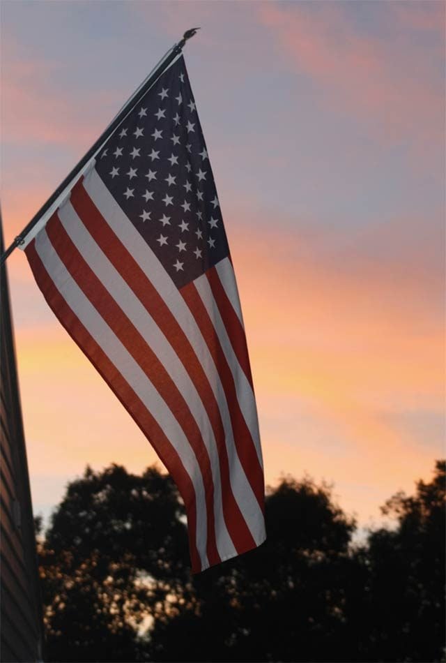 an american flag at sunset