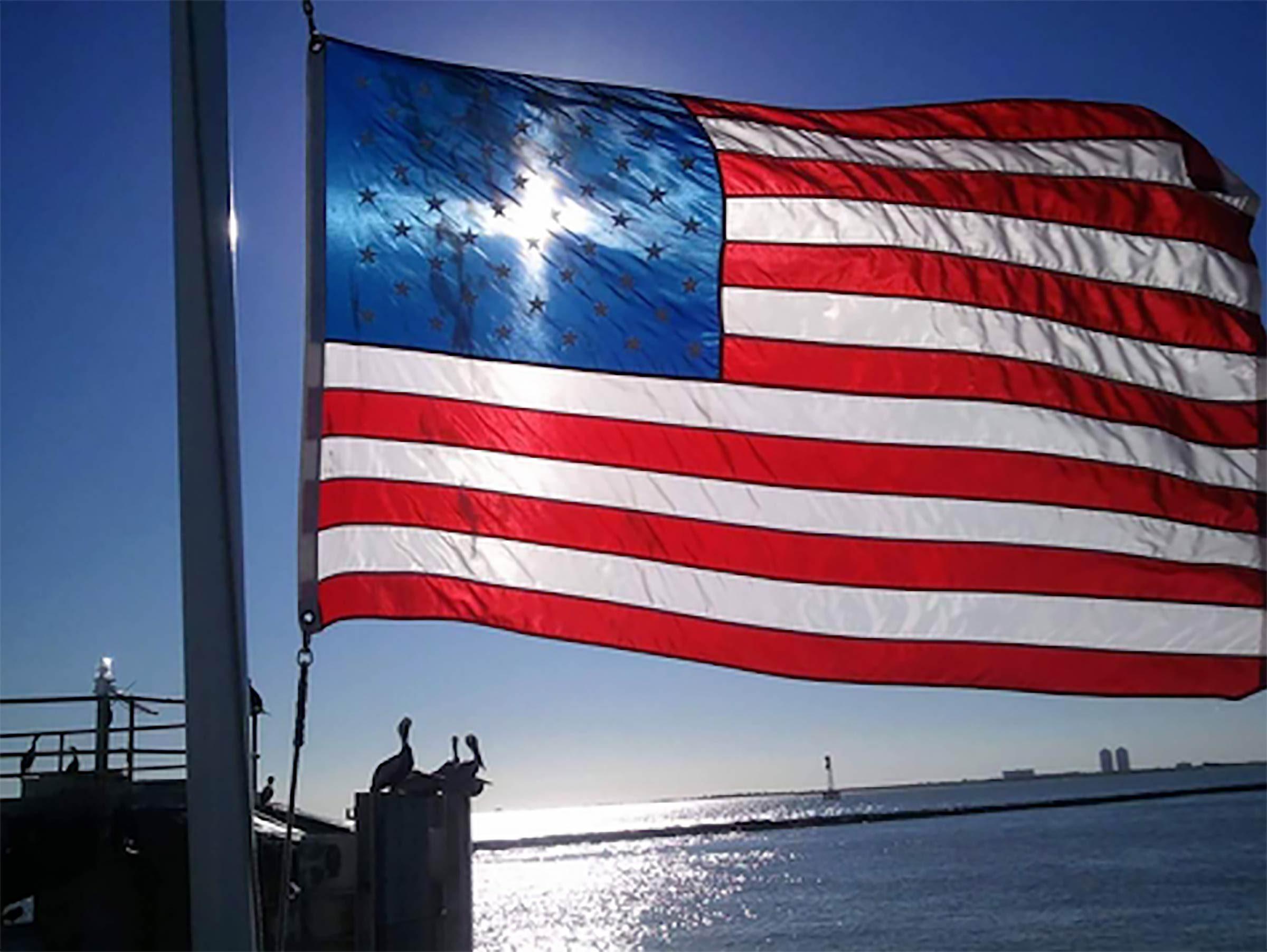 sunlit american flag at the Bolivar ferry landing