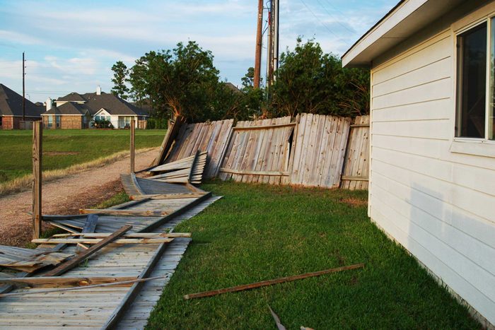 home with fallen fence after hurricane