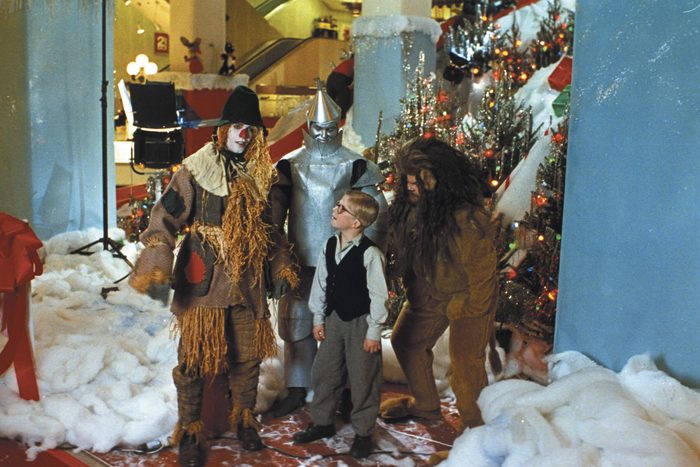 A scene from A Christmas Story with a young boy and characters from the wizard of oz