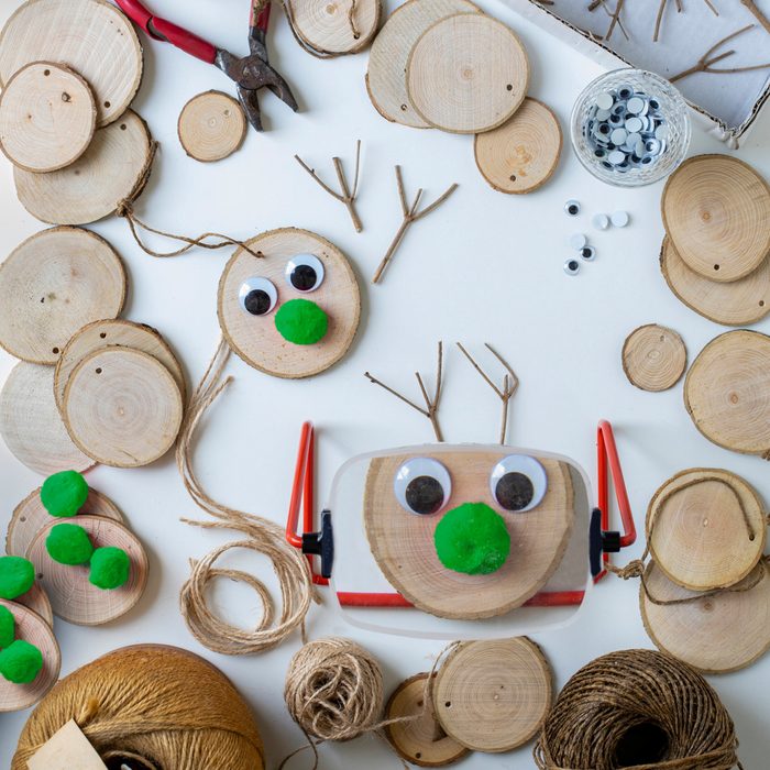 A table top view of a handmade reindeer Christmas decorations in the process of being made on a table top.