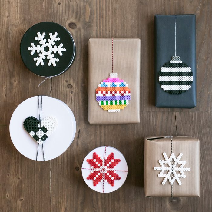Scandinavian style wrapped Christmas presents with gift tags made out of ironing beads