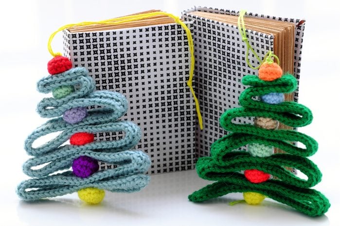 Christmas ribbon tree and colorful baubles with paper notebook on white background for decor winter holiday, handmade ornament for decorate crochet from yarn