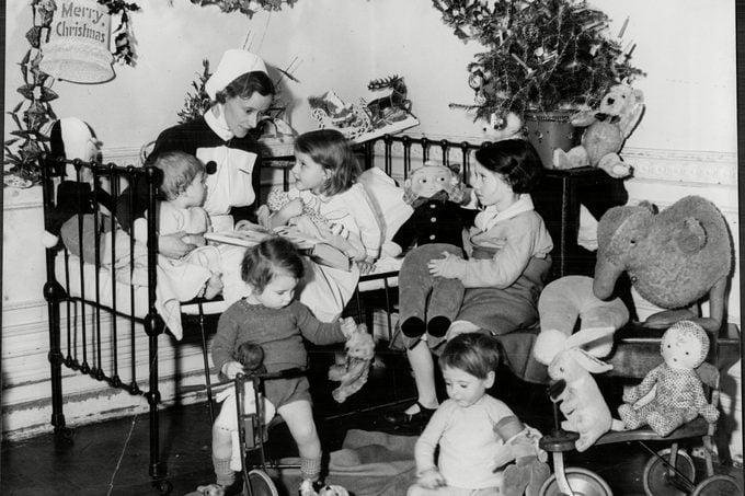 A Nurse With Children Surrounded By Christmas Presents At The Children's Hospital Hampstead - Christmas 1936.