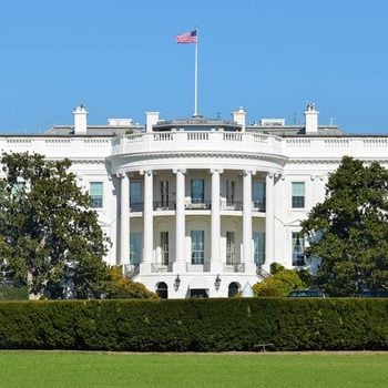front facing photo of the White House and White House lawn
