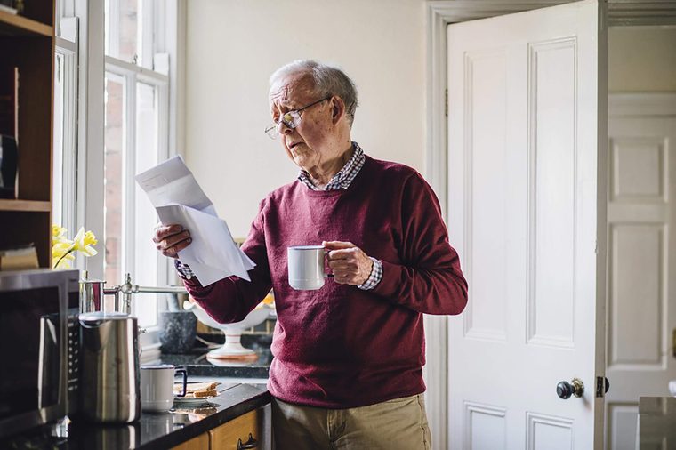 Elderly-man-reading-bills