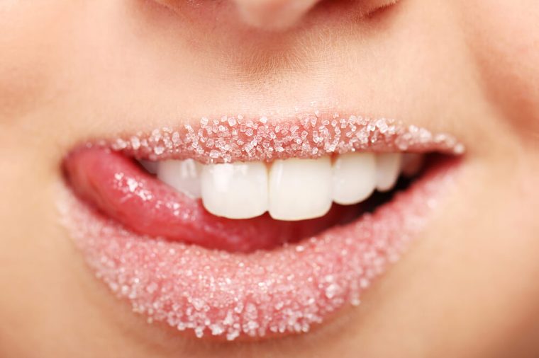 Close up of woman's lips covered with sugar