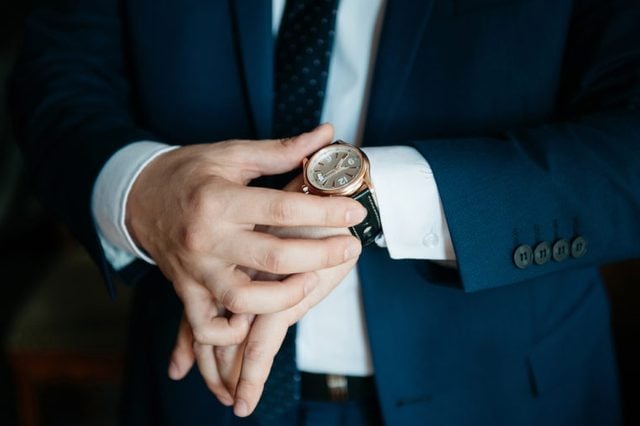 businessman looking at his watch on his hand, watching the time