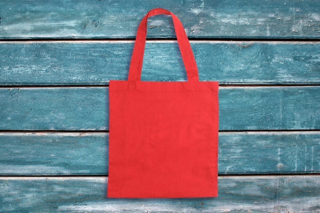 Red tote bag on blue wooden vintage background or texture