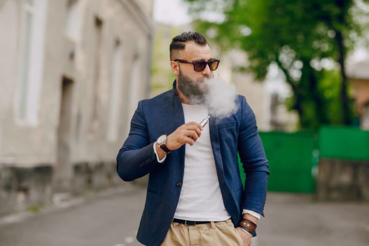 bearded man with e-cigarette outdoors