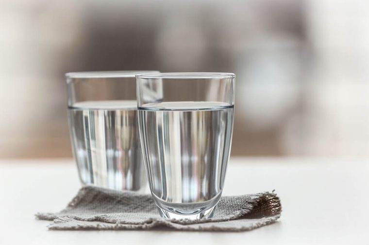 Two glasses of pure water on blurred background