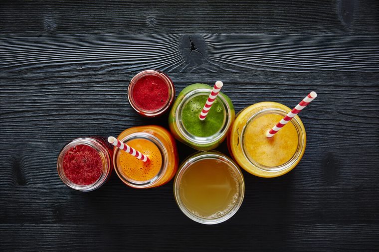 a bunch of colorful organic smoothies ready to drink