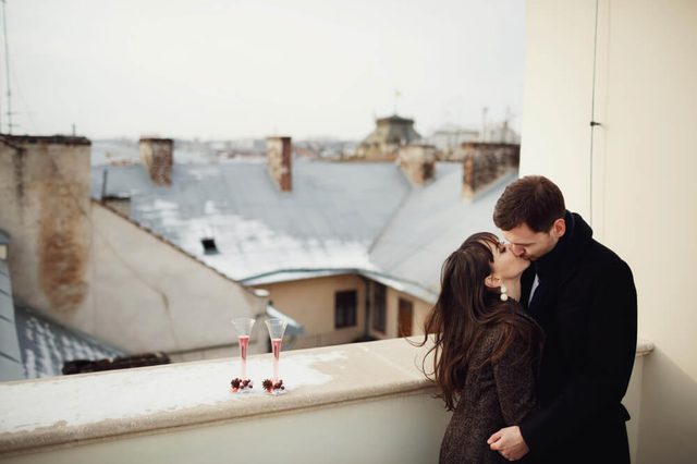 beautiful and young couple kiss each other on terrace