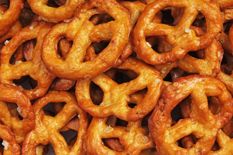 Pretzel shaped bread sticks cracker texture pattern. Salted pretzels. Mini pretzel snack texture.