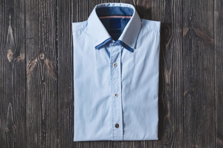 Men's classic blue folded cotton shirt with long or short sleeve on black brutal background