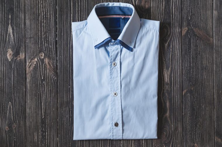 Men's classic blue folded cotton shirt with long or short sleeve on black brutal background
