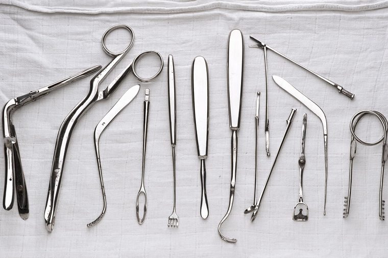 set of surgical instruments on white gauze
