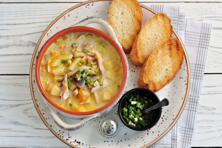 Cheese soup with mushrooms, chicken, potatoes and carrots.