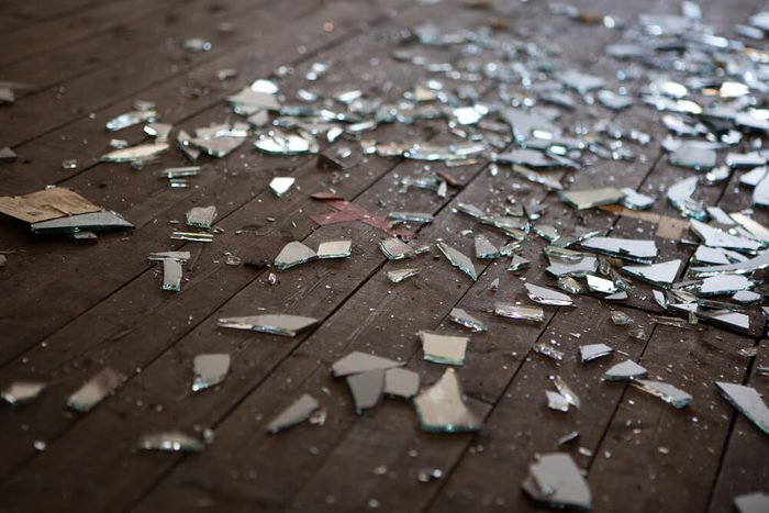 Pieces of shattered glass or mirror in an abandoned house