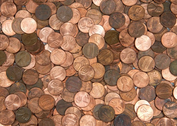 Flat view pennies. United States currency penny, many old new dirty clean viewed from directly above. The penny is the lowest denomination coin in the U.S. currency.