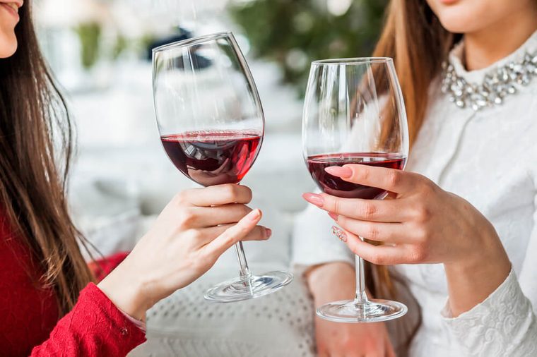 Two female friends drinking wine in restaurant
