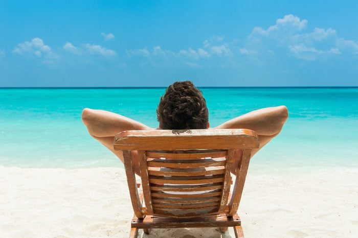 Man relaxing on beach, ocean view, Maldives island