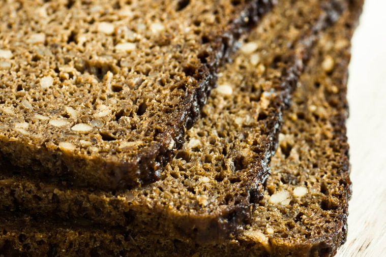 Stack of slices of wholemeal rye bread with seeds, close up