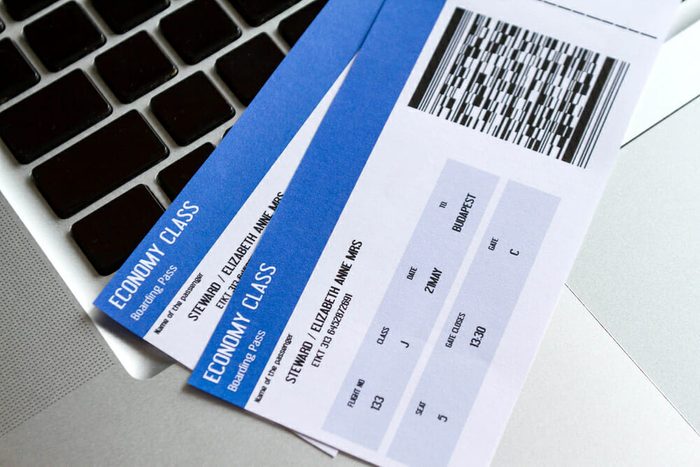 Airline tickets over the keyboard of a laptop 
