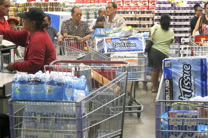 Shoppers stock up on cases of bottled water and other supplies in preparation for a hurricane and tropical storm heading toward Hawaii at the Iwilei Costco in Honolulu on . Two big storms so close together is rare in the eastern Pacific, and Hurricane Iselle could make landfall by Friday and Tropical Storm Julio could hit two or three days later, weather officials said