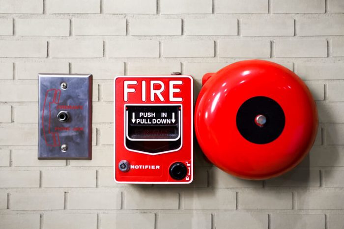 Fire alarm switch on brick wall texture background