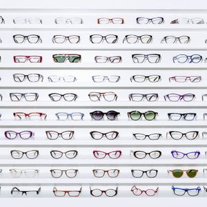 exhibitor of glasses consisting of shelves of fashionable glasses shown on a wall at the optical shop 