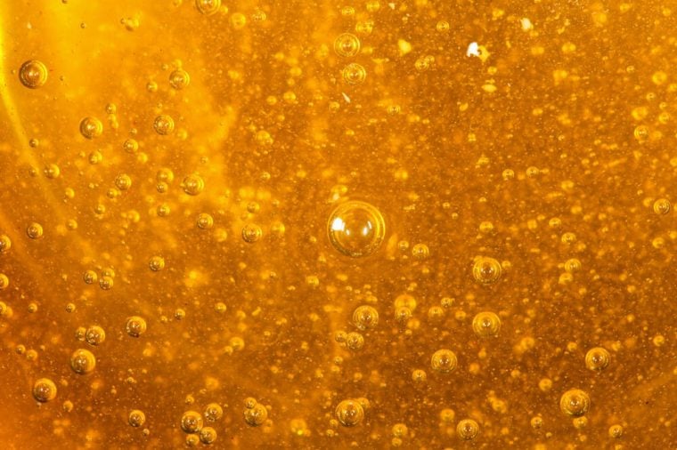 Close up photo of golden colored acacia honey