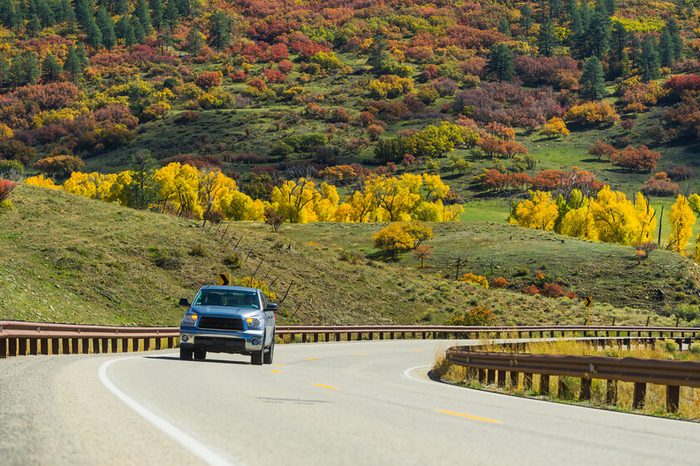 North american endless asphalt mountain road with a pickup in beautiful sunny autumn weather somewhere in the USA
