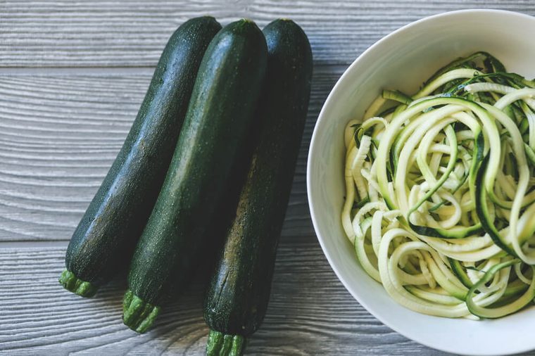 Zucchini noodles with zucchini over a table