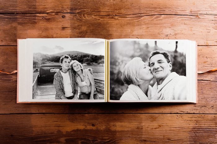 Photo album with black-and-white pictures of senior couple.